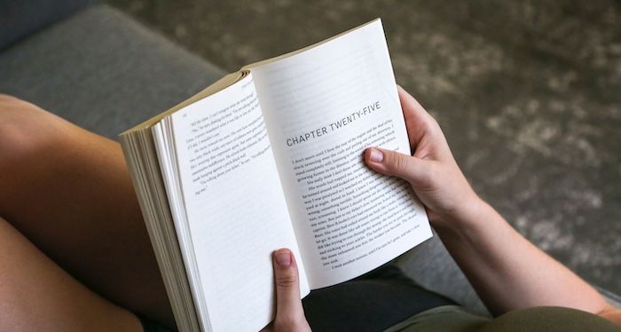 person holding paperback book.jpg.optimal