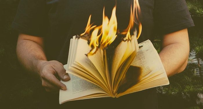 image of a person holding a burning book.jpg.optimal