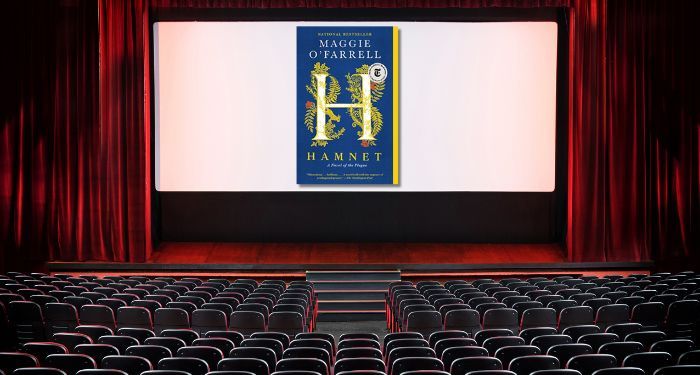 hamnet book cover on movie theater screen with empty seats in audience.jpg.optimal