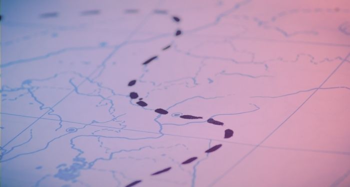 map with black inked tracks with blue and pink gradient overlay.jpg.optimal